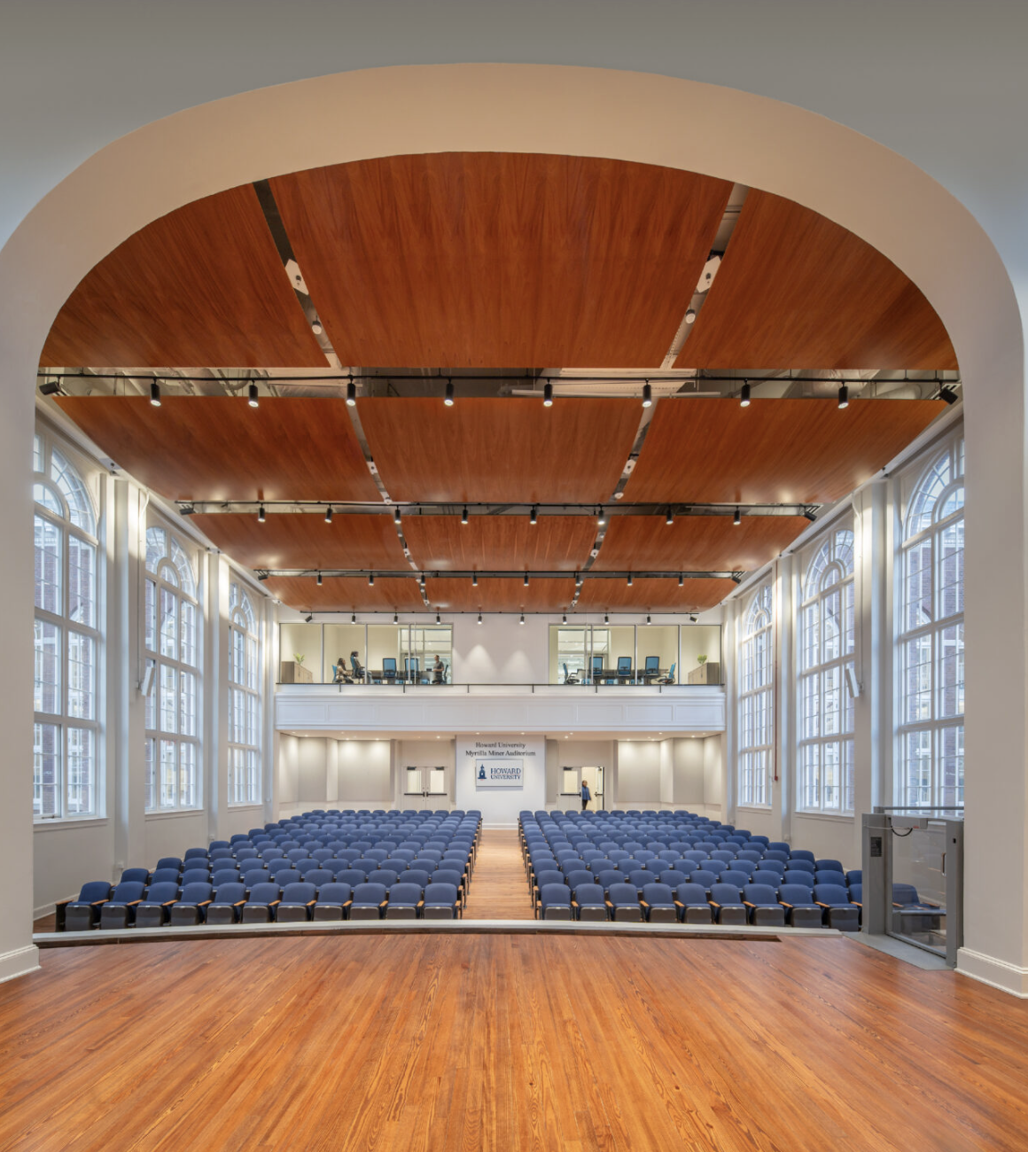 Historic wooden auditorium at Howard University's Miner Building with soft daylight